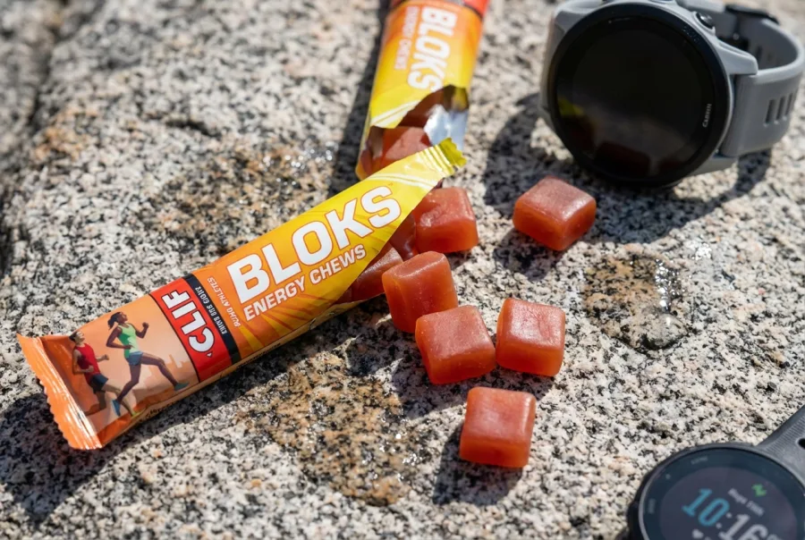 Clif Bloks Energy Chews sleeve open with soft square chews on granite surface