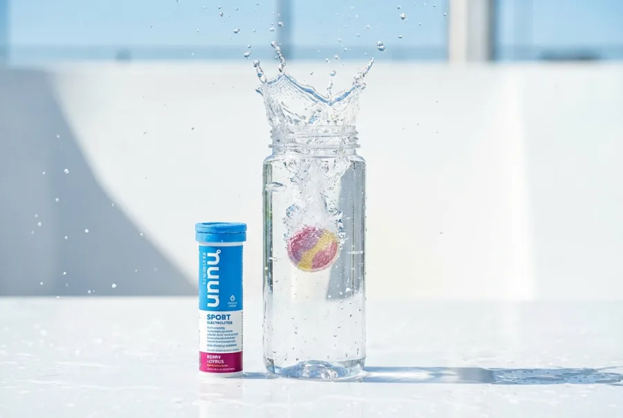 Nuun Sport electrolyte tablet dropping into clear water bottle creating fizz