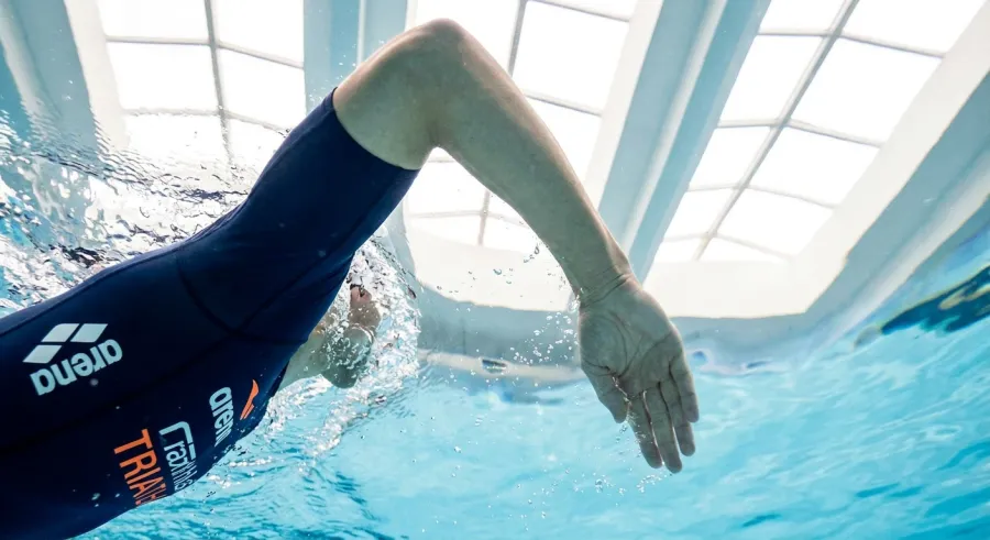 Close-up underwater view of high-elbow catch position during freestyle stroke