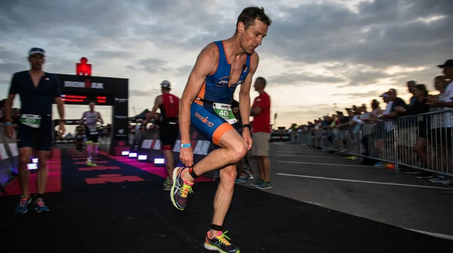 Triathlete in T2 transition putting on running shoes