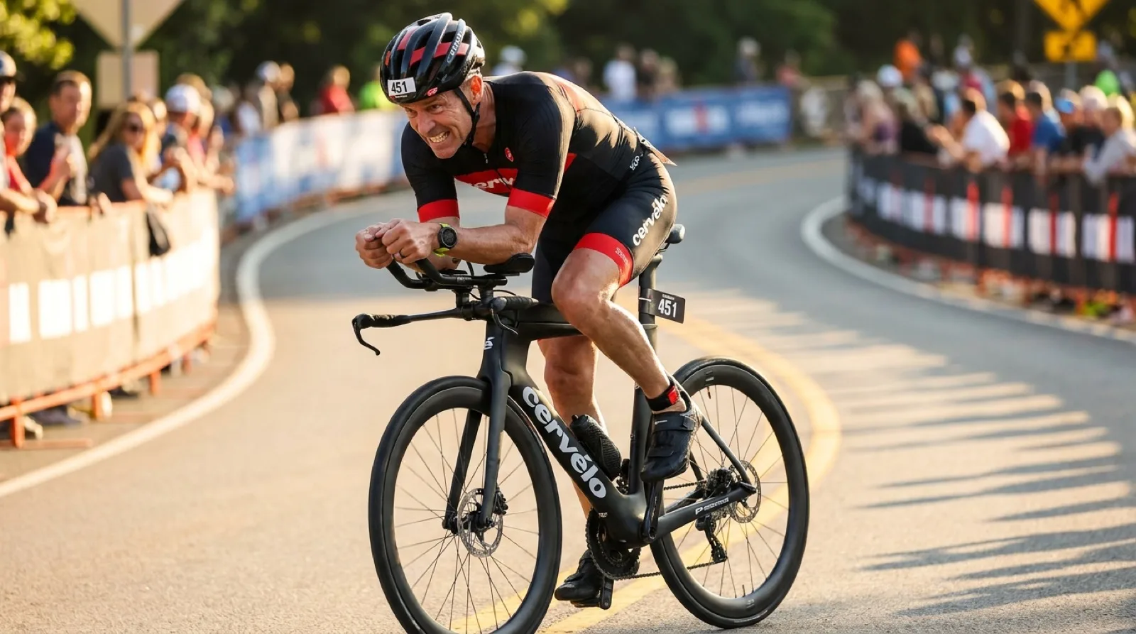 Masters triathlete in his mid-50s riding a Cervélo TT bike in aero position during a race