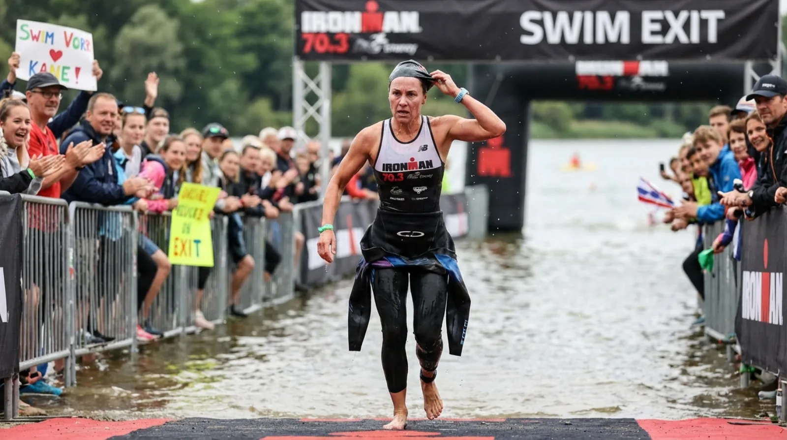 Triathlete running out of water at swim exit