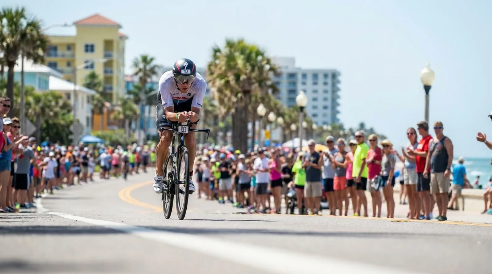 Professional triathlete on a time trial bike in full aero position during a race