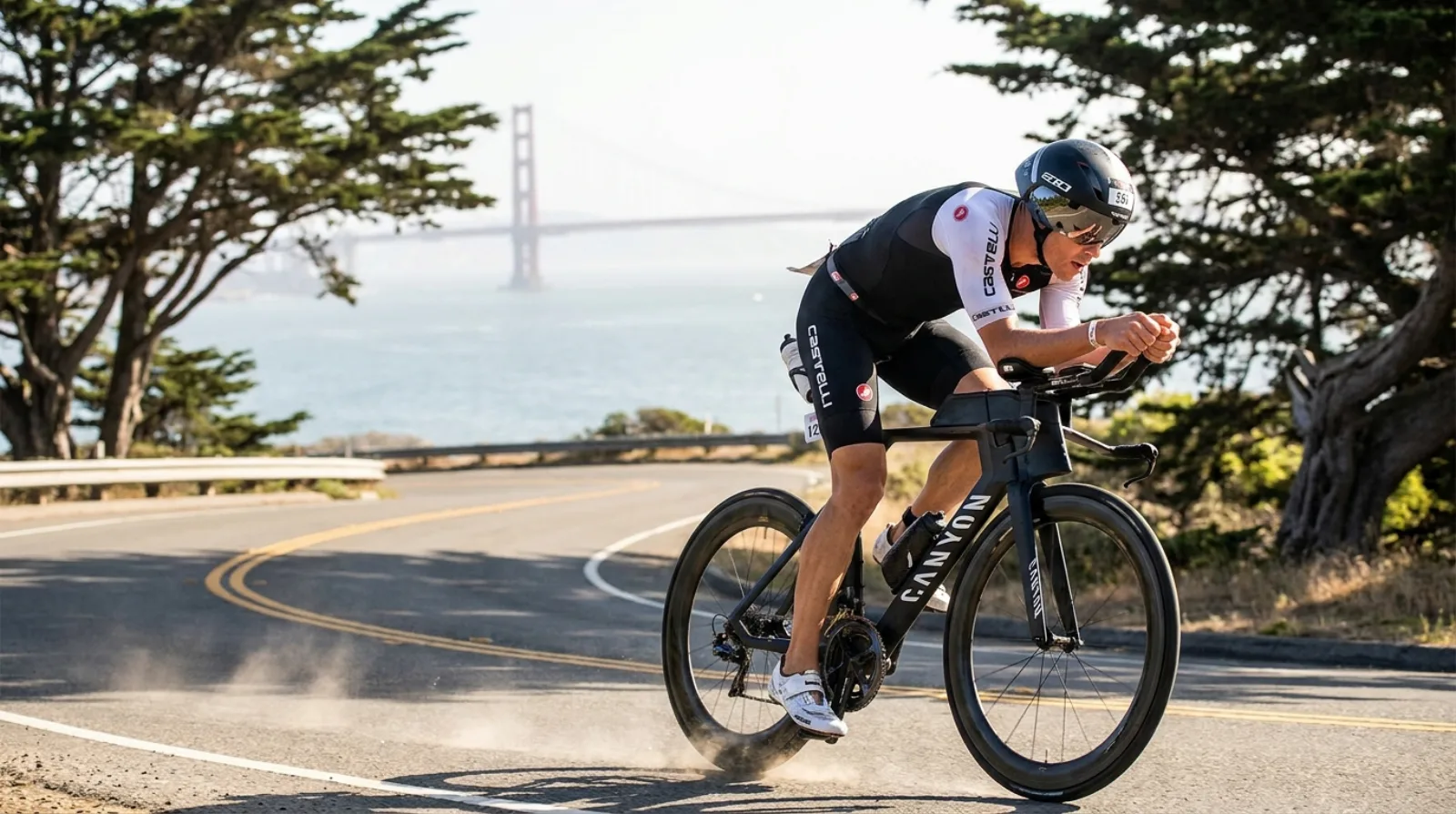 Professional triathlete in Canyon aero position racing through the Presidio with Golden Gate Bridge in background