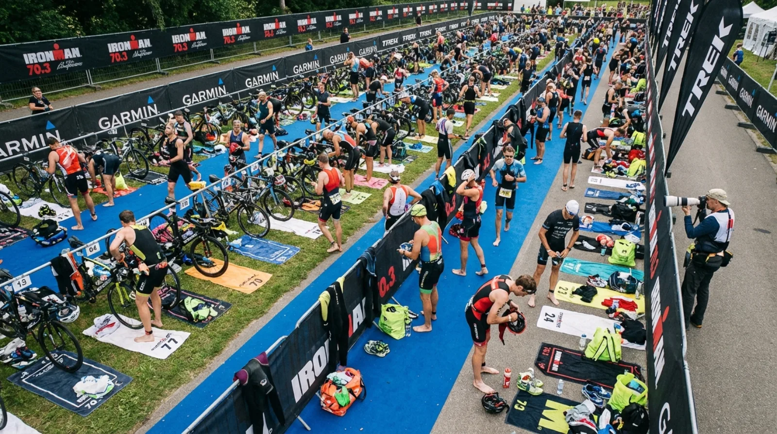Triathlete in transition zone, bike racked, gear laid out
