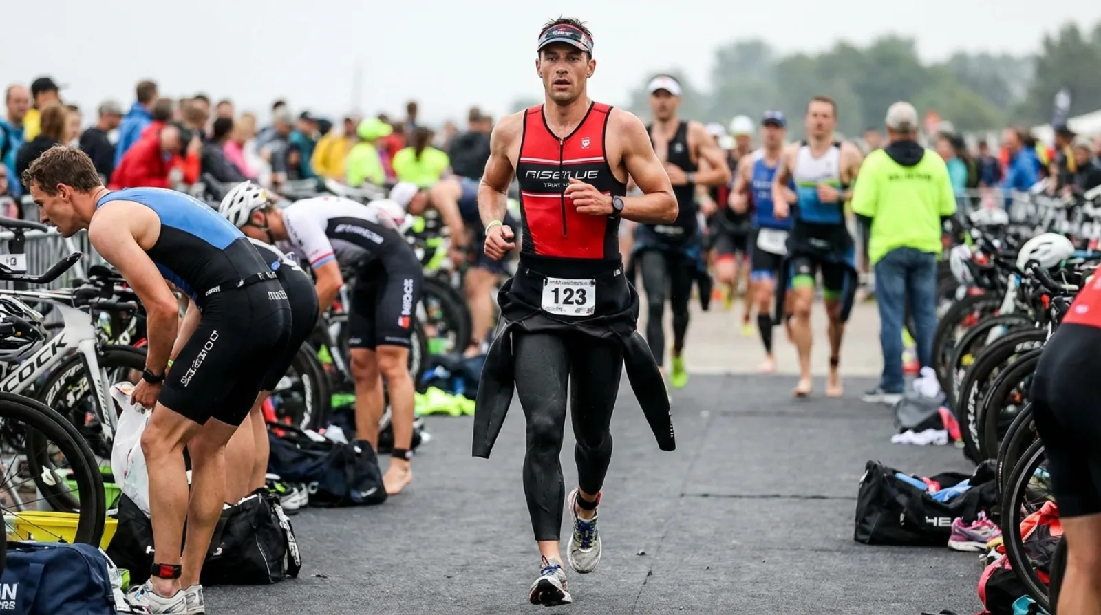 Triathlete running with wetsuit peeled to waist
