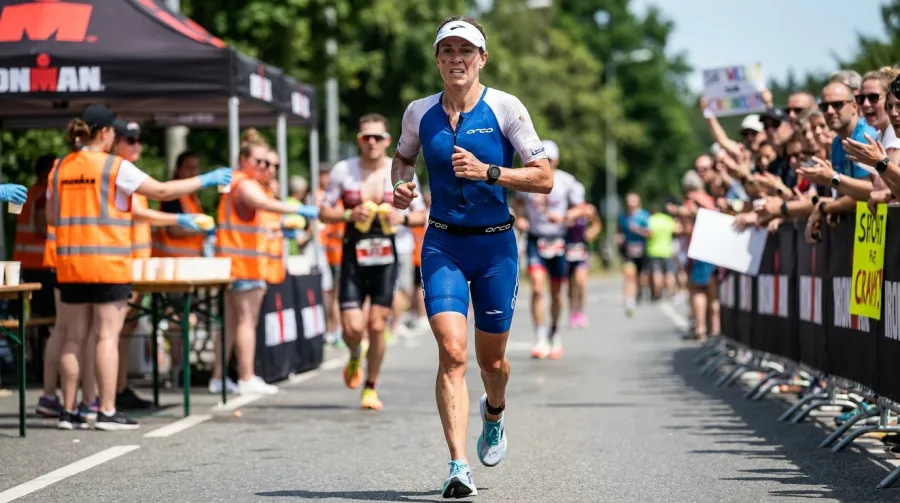 Female triathlete pushing through exhaustion on the IRONMAN run leg